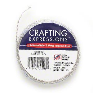 Seed bead, Westrim®, glass, silver-lined clear, size 11, strung on steel wire. 5 yards
